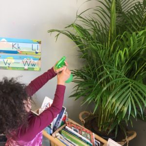 child watering plant